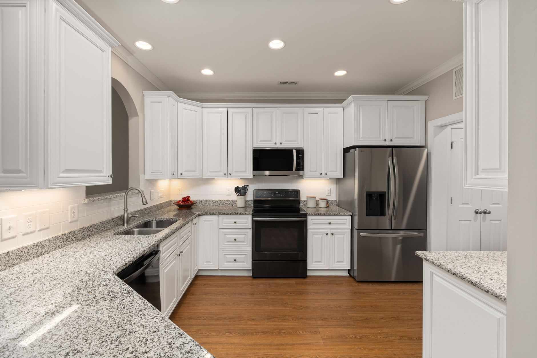 Sleek kitchen with stainless steel appliances and granite countertops, perfect for modern homes in Riverside, CA